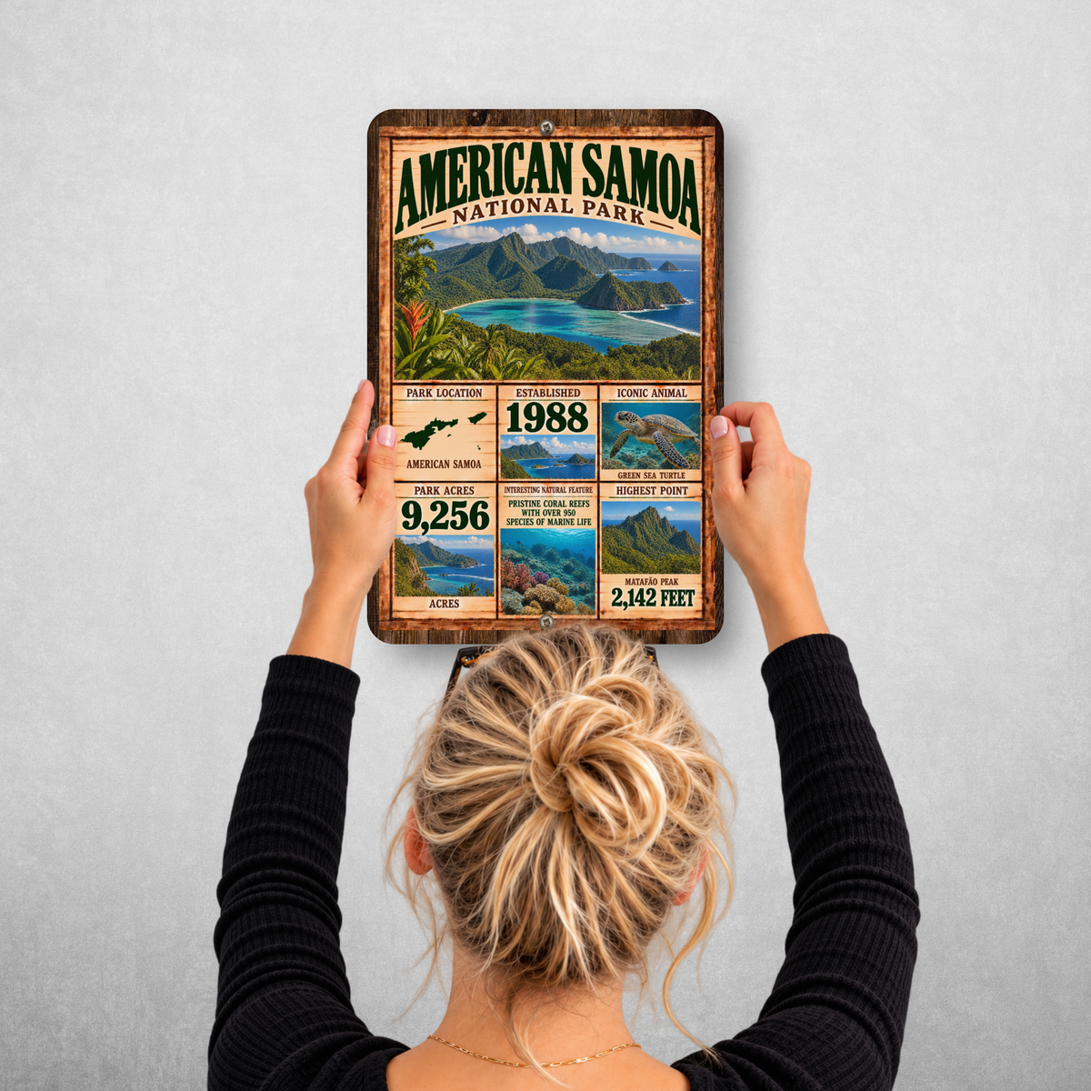 Person hanging the American Samoa National Park aluminum sign on a wall
