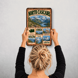 North Cascades National Park facts sign hanging on a wall with vintage mountain and lake artwork